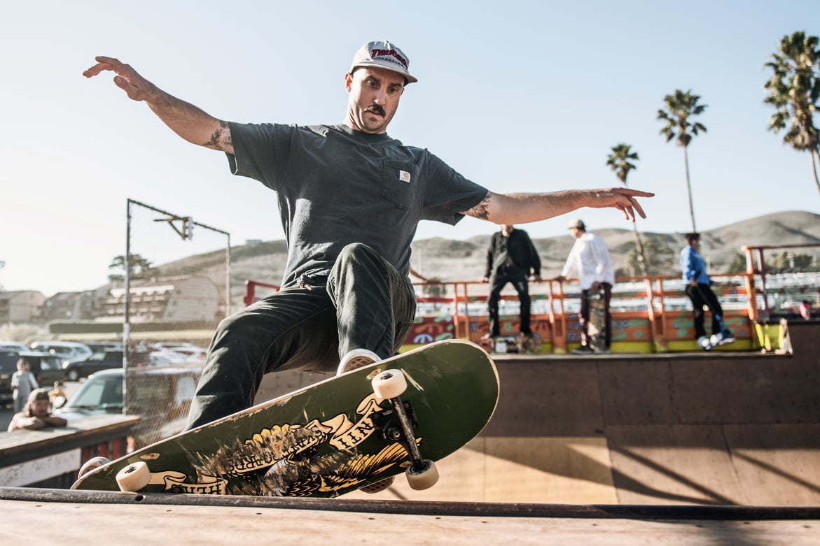  A Low Angle Shot of a Man in Black Pants Riding a Skateboard